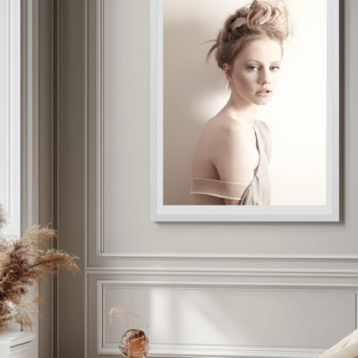 Shop 8 Framed fine art photograph of a woman with soft lighting and muted tones, displayed in an elegant, light-filled room.