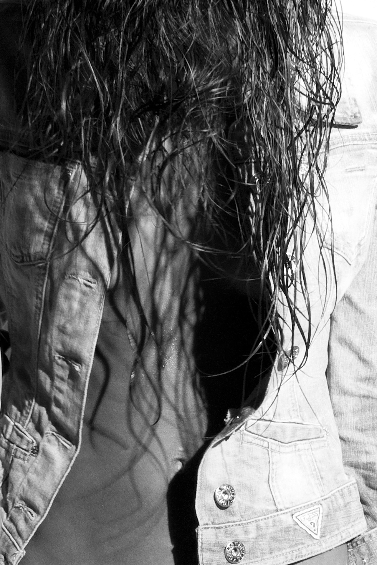 Denim Noir 3 Close-up of model in wet denim jacket, highlighting shadows and textures by Liäns Jadän